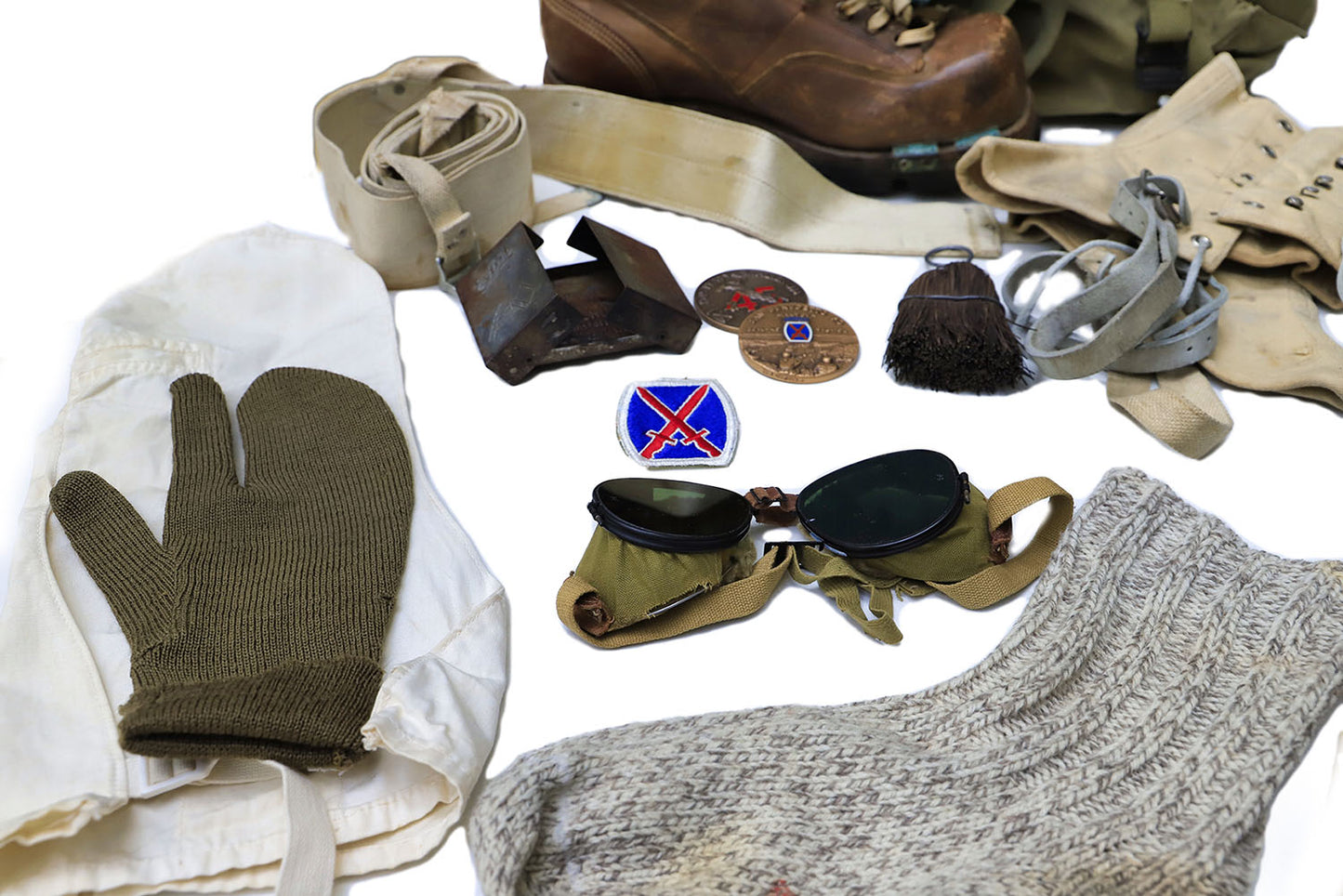 Items from the 10th Mountain Division Artifact Kit: mitten, goggles, stocking, patches, and other gear.