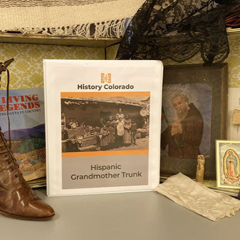 collage including antique women's leather dress boots, retablo, lace veil, wooden cross, and teacher manual for Hispanic Grandmother Trunk.