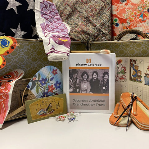 collage with Japanese paper fan, butterfly kite, Japanese sandals, chopsticks, and teachers guide in binder.