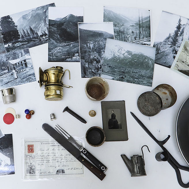 A collection of items from the artifact kit, including photographs, utensils, and mining tools.