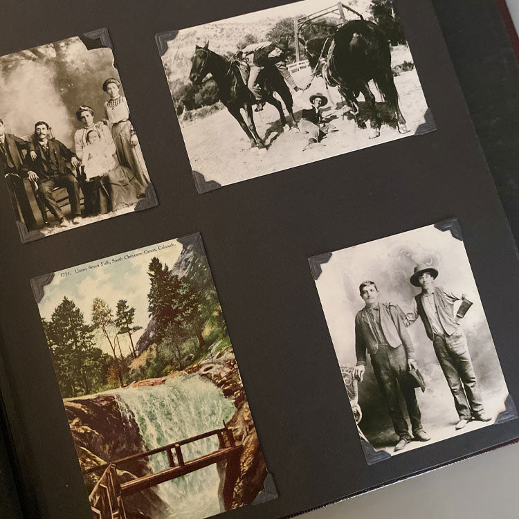 photo album with historic photos of a family, two men, two men and two horses, and a postcard with a waterfall.