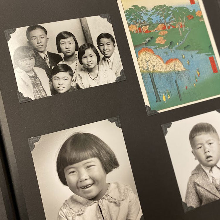 photos pf Japanese family, young girl, young boy, and postcard with drawing of lake and trees mounted in a photo album.