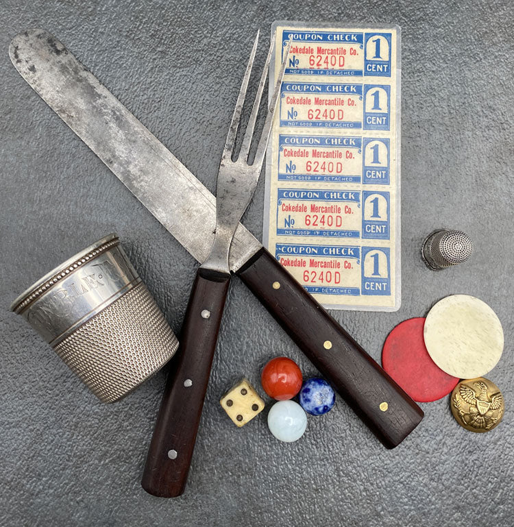 Knife and fork, thimble, marbles and dice, Cokedale Mercantile coupons and a metal button.