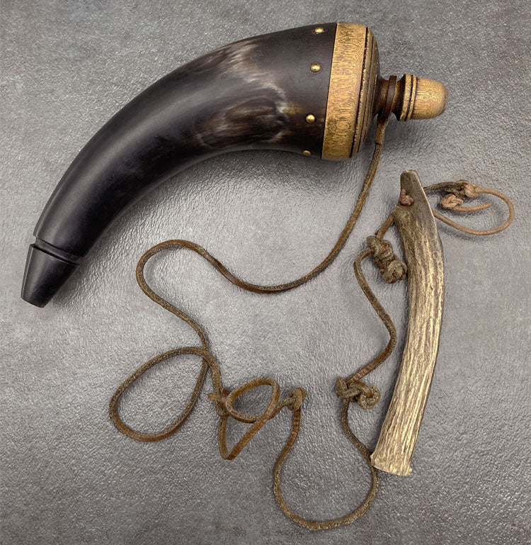 Gun powder horn made from antler, with leather string and bone attachment.