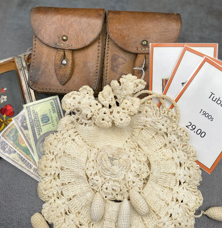 Small leather bag, crochet women’s purse, fake money game pieces, embroidered wallet and game cads with Tuba 1900s 29.oo printed on the card.